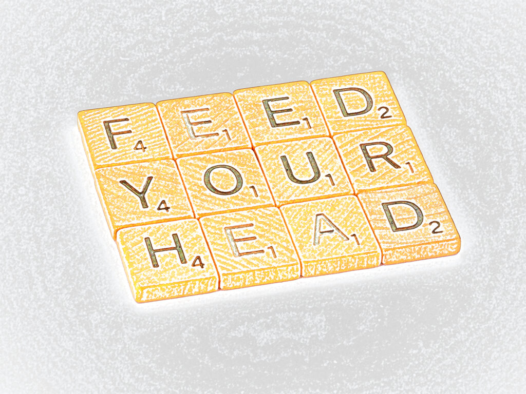The words 'Feed Your Head' in Scrabble tiles, denoting an efficient learning method.